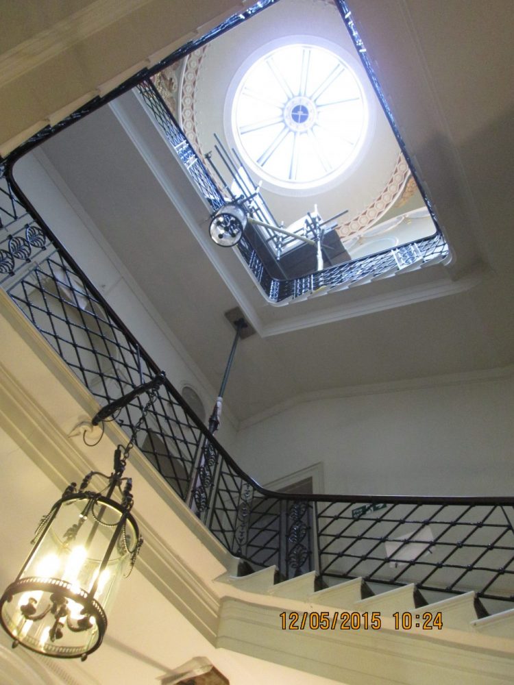 cantilevered stone staircase with iron balustrade